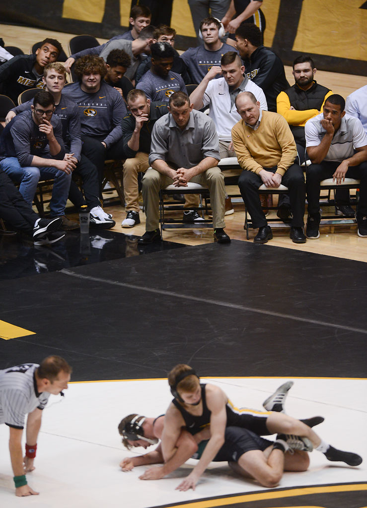 The Missouri bench looks on as Cameron Valdiviez wrestles